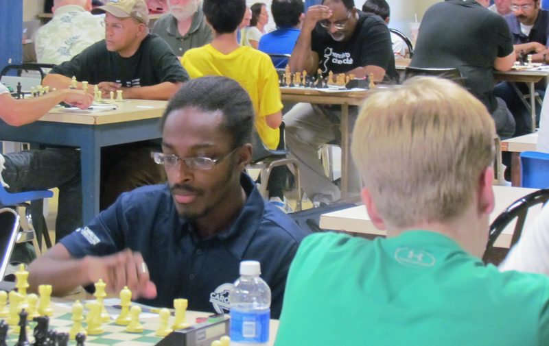 Two players concentrating over a board