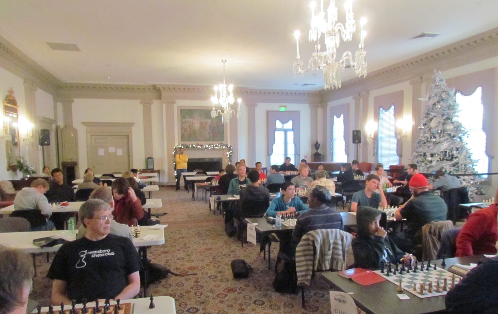Players at tables during a Greensboro Chess Club tournament